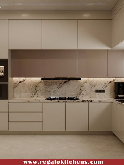A beautiful two-tone L-shaped kitchen with beige and brown cabinets. The design includes integrated double ovens and a marble backsplash, creating a warm and functional space. Under-cabinet lighting ensures the work area is always well-lit.