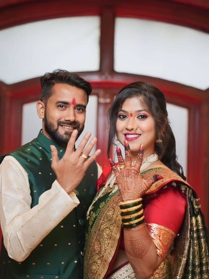 Dipesh and Hemangi smiling for the camera, displaying their rings. This portrait captures their happiness and the significance of the occasion.