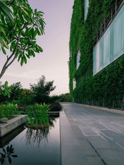 The base of the KMC Headquarters features a tranquil water body that complements the living wall above. This integration of water and plants is a holistic approach to creating a micro-climate around the building.