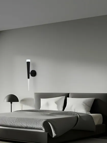This torch-style wall sconce provides a soft, ambient light that is perfect for creating a relaxing atmosphere in a bedroom.