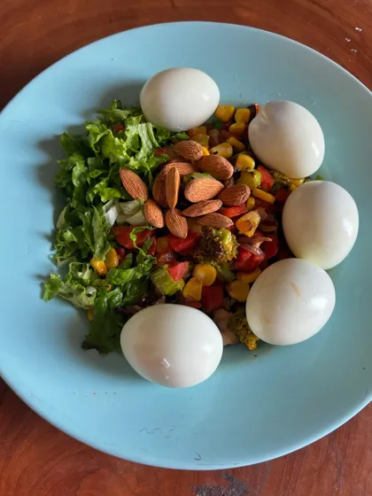 A balanced, high-protein meal of boiled eggs, almonds, and a fresh vegetable salad. This is what fueling your body for performance looks like.