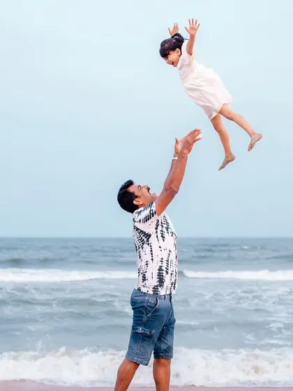 For me, the best family portraits are the ones filled with pure, unscripted joy. This moment of a father and daughter playing on the beach, with the sky as their canvas, is what it's all about. It’s these candid, playful memories that truly capture the heart of a family.
