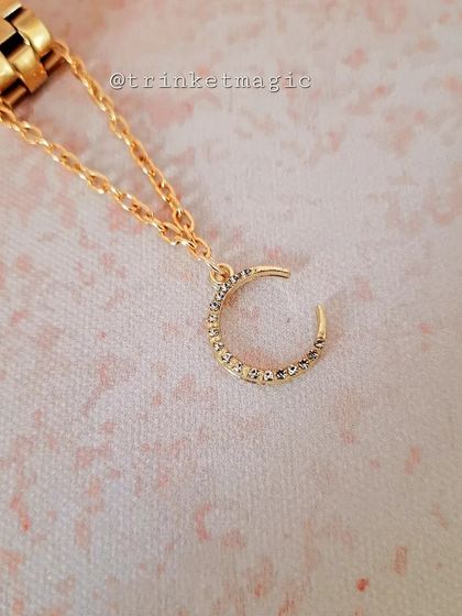 The same sparkling crescent moon watch charm, this time in a gold finish. It's a versatile accessory that matches any watch.