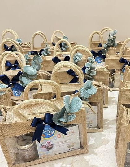 For a more rustic and eco-friendly option, we offer these charming jute bags for baby announcement hampers, complete with a clear window to peek at the goodies inside.