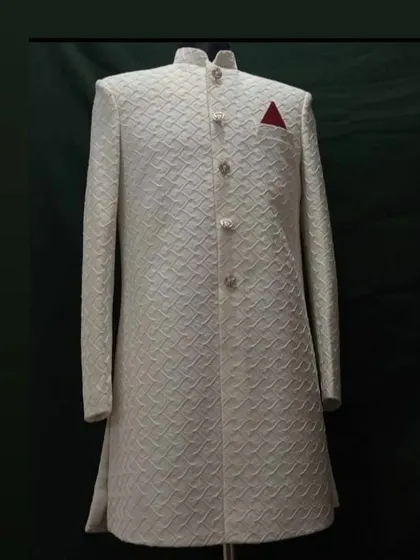 A classic off-white sherwani, perfect for a groom. I focus on getting the details right, from the intricate self-patterned fabric to the structured, clean tailoring that guarantees a royal look.