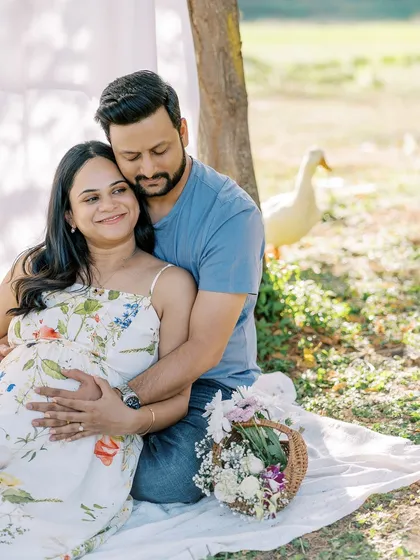 A fun and candid moment from their outdoor picnic session. The unexpected visit from a duck adds a touch of humor and makes the memory even more unique.