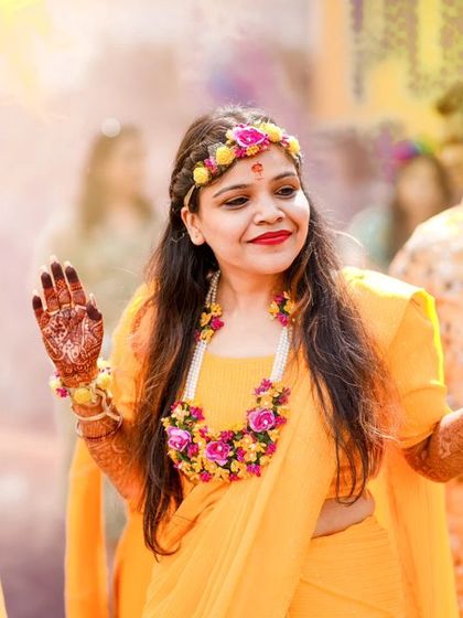 The bride's joyful dance during her Haldi ceremony. My focus is on capturing movement and genuine expression, telling the story of a celebration in full swing.