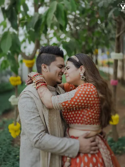 A happy, candid embrace between the bride and groom. Their genuine smiles and the natural setting create a portrait that feels warm, authentic, and full of love.