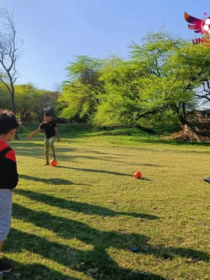 Our players watching a demonstration closely. Learning by observing is a key part of our coaching method, helping them understand the mechanics of each skill.