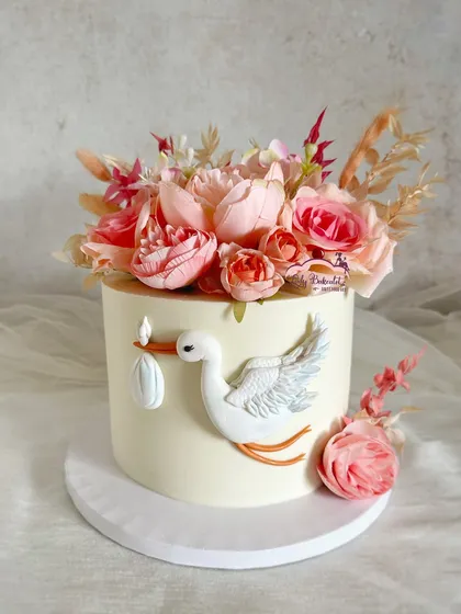 Special delivery! A classic baby shower cake featuring a stork and beautiful pink florals.