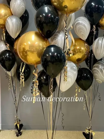 A stylish balloon bouquet featuring black, gold, and marbled-pattern balloons. This is a great choice for sophisticated parties, anniversaries, or corporate events.