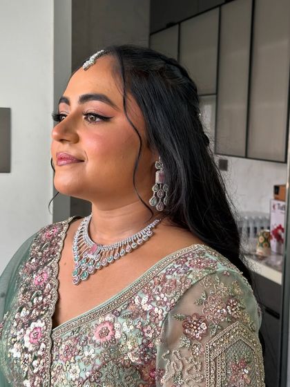 A side profile showing off her half-up hairstyle and glowing skin.