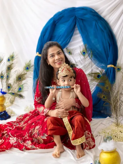 A beautiful mother and son portrait during a Janmashtami shoot. The little Kanha is sitting happily in his mother's lap.