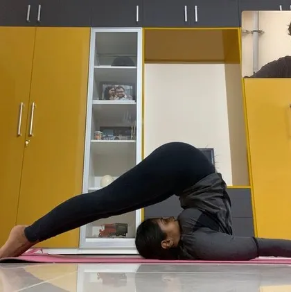 Join my advanced yoga classes online from anywhere in the world. In this virtual session, I am guiding a student through Halasana, or Plow Pose. My online classes provide the same level of detailed instruction and support as my in-person sessions, helping you progress in your practice from the comfort of your home.