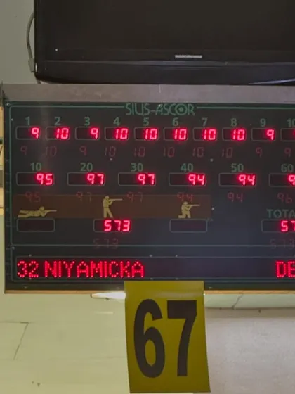 The electronic scoreboard displaying Niyamicka's impressive score of 573/600 in the 10m Air Pistol event. This is a testament to her precision and consistency under pressure.