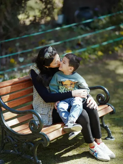 A sweet kiss from mom. These quiet, tender moments are just as important to capture as the playful ones, showing the gentle side of your family's love story.