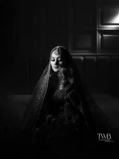 In the quiet moments before the vows, a bride's beauty shines brightest. We use dramatic lighting and monochrome tones to create timeless, artistic bridal portraits that feel both powerful and serene, capturing the soul of the moment.