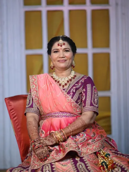 A poised portrait of the groom's mother. Her smile is the best accessory to the timeless makeup and traditional attire.