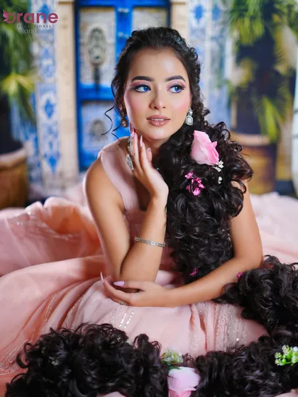 The use of blue contact lenses and dreamy makeup transforms the model into a real-life fairytale princess.
