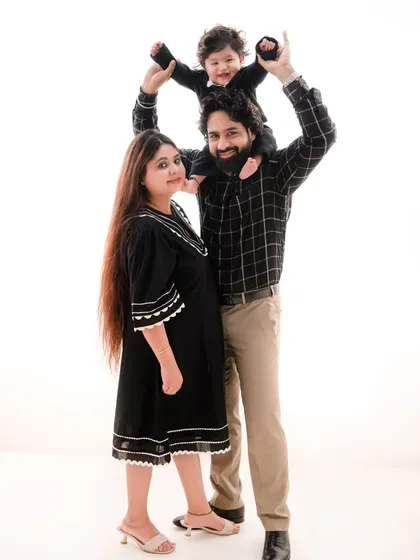 A playful family pose with the son enjoying a ride on his father's shoulders. This shot perfectly blends a classic portrait setup with a fun, candid feel.