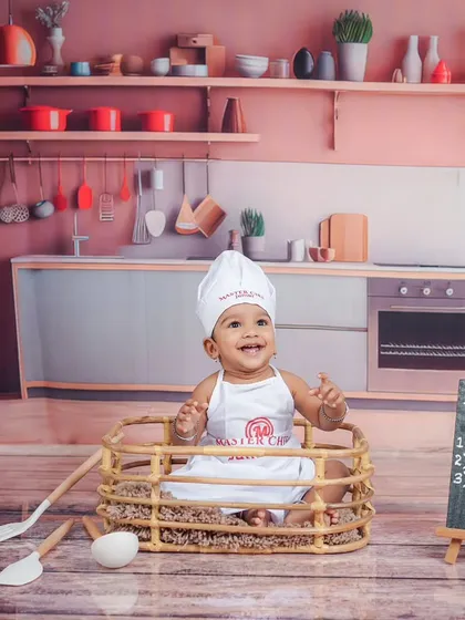 Let's get cooking! My studio has a variety of fun themes, like this 'Master Chef' setup, complete with a tiny chef's hat and a kitchen backdrop for your little foodie.
