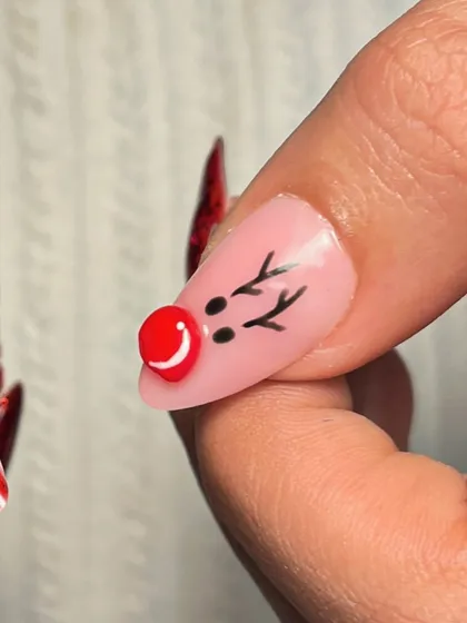 The cutest little 3D reindeer nose detail. I used a red bead to create this fun and festive accent for a Christmas-themed manicure.