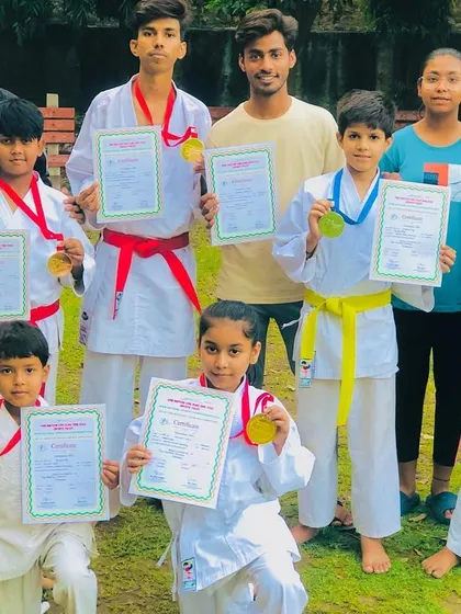 A group of my medalists holding their certificates and medals. Each one is a champion in their own right.