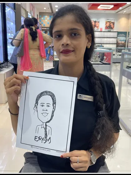 An employee at the Titan store in Viviana Mall with her caricature. We love bringing smiles to both customers and staff during in-store events.
