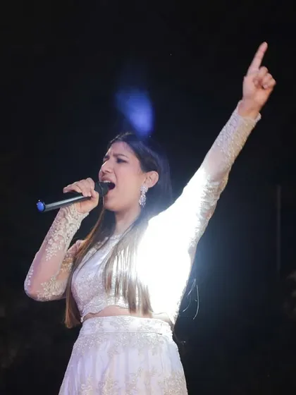 Raising my hand to hype up the crowd. As an emcee, my energy is infectious and crucial for keeping the party going all night long.