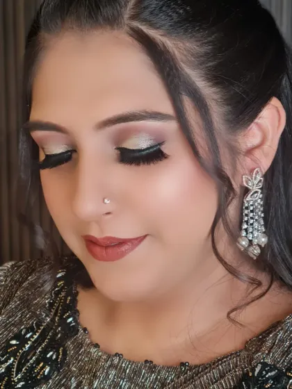 A close-up of the beautiful eye makeup. The silver shimmer and winged liner create a glamorous look perfect for any party.