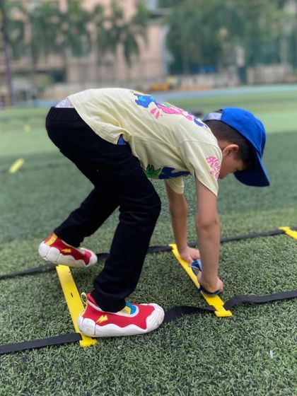 A young athlete masters the agility ladder. These drills are fantastic for improving footwork, coordination, and speed, all while feeling like a fun game.