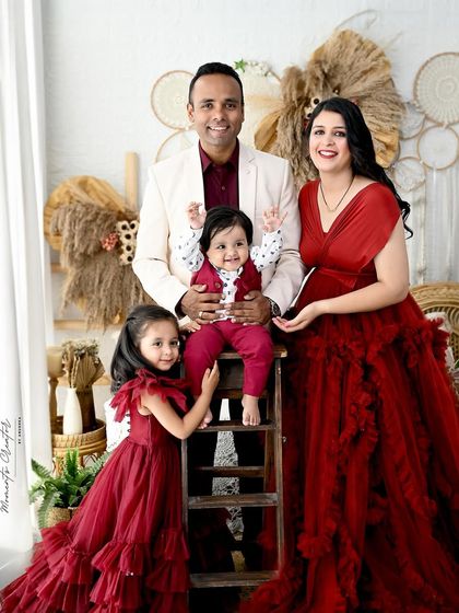 A playful family portrait with the birthday boy standing tall. The joy and energy of this family of four are perfectly captured in this fun and dynamic shot.