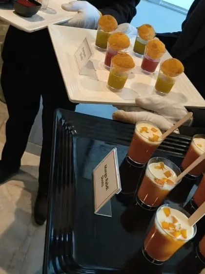 Our staff serving trays of Mango Rabdi Shots and Panipuri Shots at a corporate event. We ensure professional service and an elegant presentation for all our appetizers.