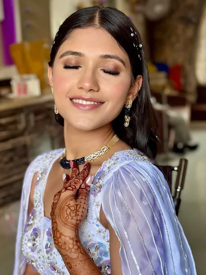 A close-up of Janvi's soft glam makeup. The shimmering eyeshadow and glossy lip are a perfect combination.