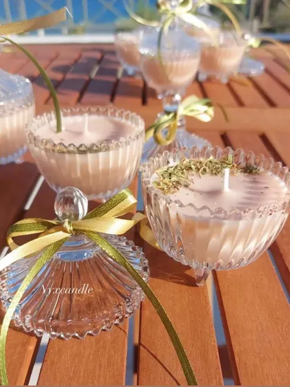 A stunning outdoor shot of our crystal jar candles, some with dried herbs for a botanical touch. These were part of a 500-piece order for a beautiful wedding celebration.