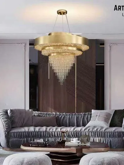 This modern take on a crystal chandelier features a tiered design within a sleek golden frame. It's a perfect fit for contemporary living rooms, blending the sparkle of crystal with a clean, sophisticated silhouette.
