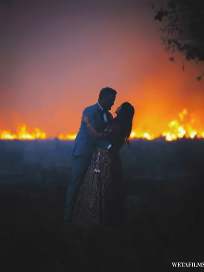Sometimes, the most unplanned moments create the most dramatic shots. We spotted a fire in the distance and seized the opportunity for this breathtaking silhouette. It shows our ability to think on our feet and create unique, powerful pre-wedding images.