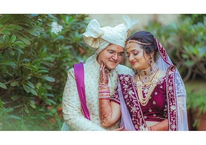 A sweet, candid moment between the couple, framed by lush greenery. I often use natural elements to create a soft and romantic feel for my wedding portraits.