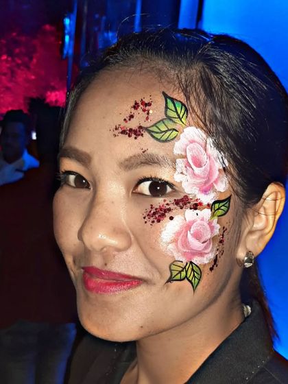 A beautiful full-face floral design with pink roses and glittery red accents.