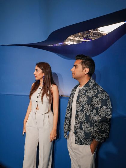 A quiet moment of reflection against the deep blue, sculpted wall. The subtle cutout offers a glimpse into the chrome interior, a design element intended to spark curiosity and invite exploration.