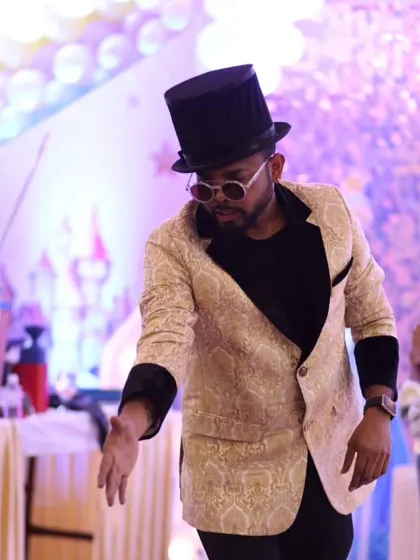 A moment of concentration during my show. I am deeply focused on my craft, ensuring every trick is performed flawlessly to create a seamless and magical experience for the audience.