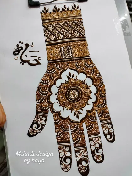 A clear, top-down shot of the mandala design on a practice sheet. This is the kind of reference material we use in class to study and replicate complex patterns.
