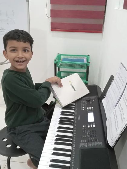A happy student at his keyboard lesson. We believe learning music should be a joyful experience.