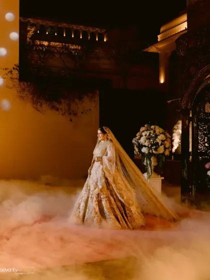 The bride's ethereal entrance through a cloud of smoke at her nighttime wedding, a truly cinematic and breathtaking moment.