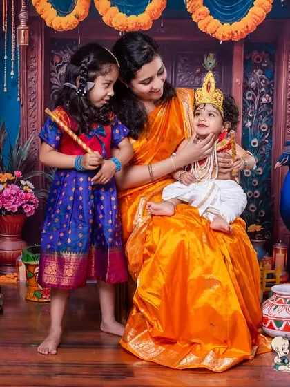 This is one of my favorite themes, capturing the love between a mother, her daughter, and her little Krishna. I create these traditional setups to help families celebrate their culture and create timeless memories together.