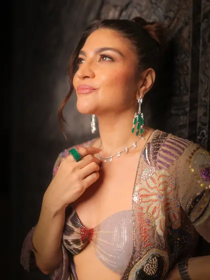 Another beautiful close-up capturing the radiant skin and sophisticated makeup. This is a perfect example of high-fashion glam.