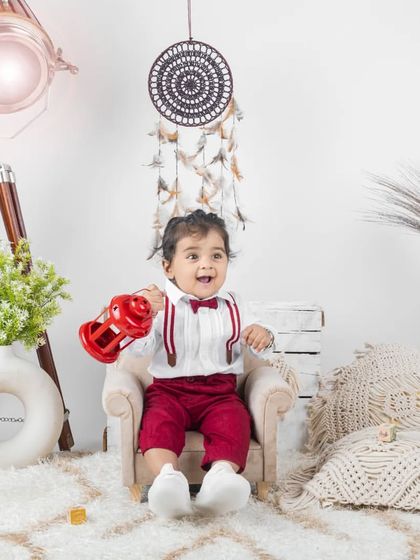 This dapper little man in his red pants and suspenders looks so handsome in our classic studio setup.
