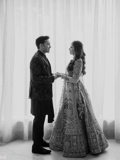 A timeless black and white portrait that emphasizes emotion and connection. By removing color, we draw focus to the couple's expressions and the beautiful details of their traditional engagement attire, creating a classic, elegant photograph.