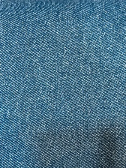 A close-up of a classic blue, non-stretch denim. This is the kind of sturdy, reliable fabric that has been used for workwear for over a century.