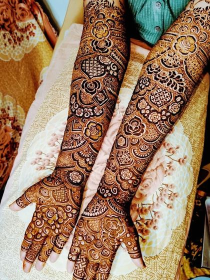 The complete bridal mehndi for Farheen, showing the detailed work on her hands and feet, and the beautiful final stain.